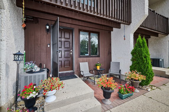 Front view of a house entrance with a small porch area and planters.