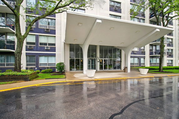 Front view of a multi-story building with a large entrance canopy.