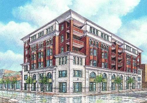 Front view of a multi-story brick building with arched windows.