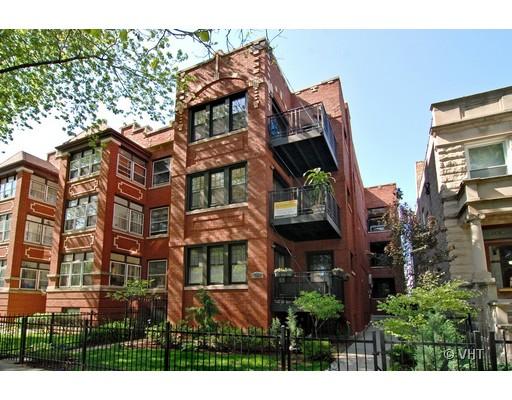 Front view of a multi-story brick apartment building with balconies.