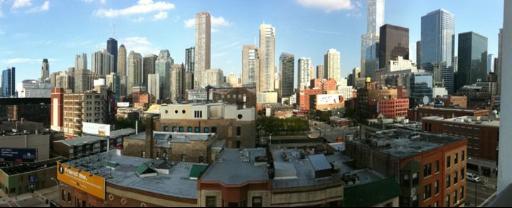 Panoramic view of a city skyline with numerous tall skyscrapers and buildings.
