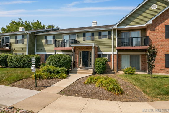Front view of a two-story apartment building with balconies.