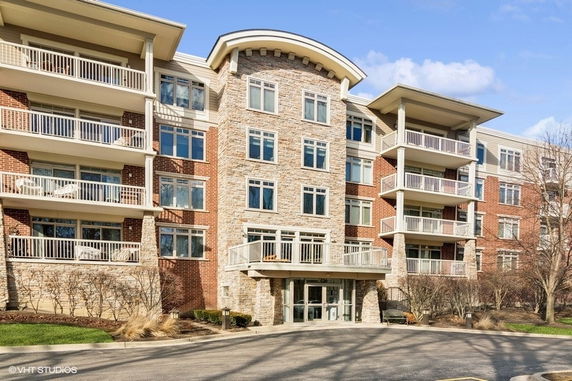 Front view of a multi-story residential building with balconies.