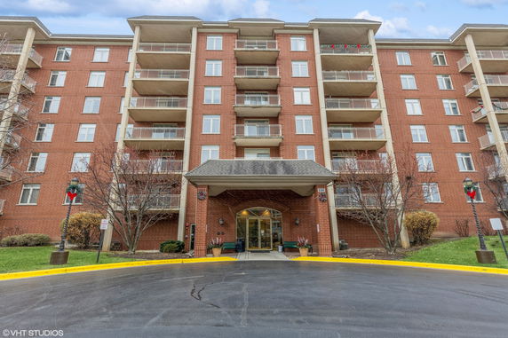 Front view of a multi-story apartment building with balconies.
