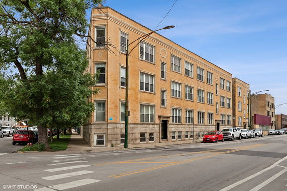 Front view of a multi-story brick apartment building.