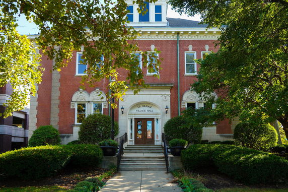 Front view of a brick building with decorative arches and windows.