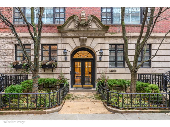 Front view of a brick building with decorative stone trim around the entrance.