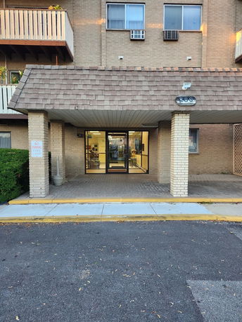 Front view of a multi-story building with an entrance canopy.