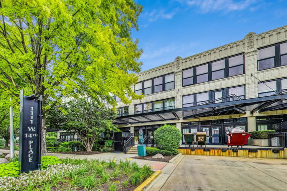 Front view of a two-story building with large windows and a modern facade.