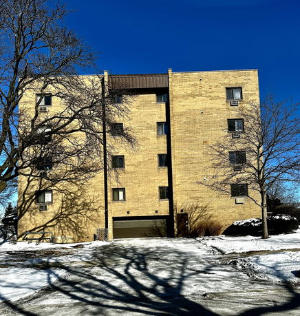 Front view of a multi-story brick building in winter.