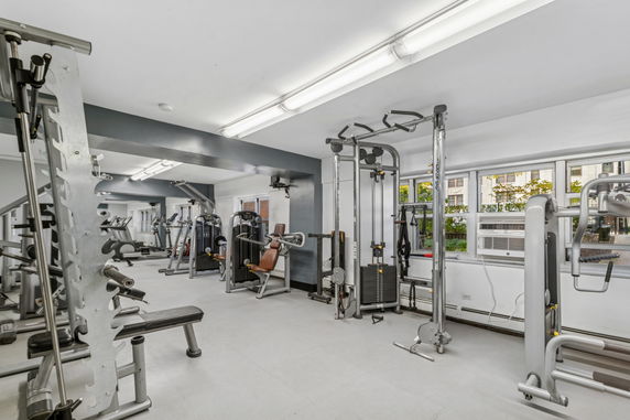 Indoor gym area with various exercise equipment.