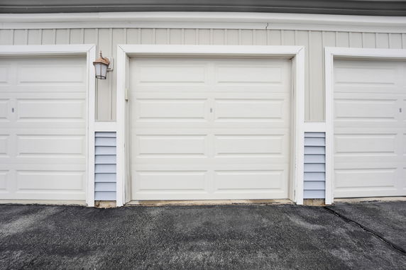 Front view of a building with triple garage doors.