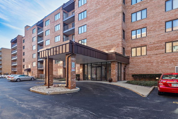 Front view of a multi-story brick building with an entrance canopy.