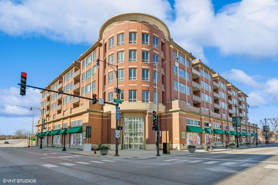 Front view of a multi-story brick building on a corner street.