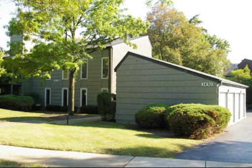 Front view of a multi-story residential building with attached garages.