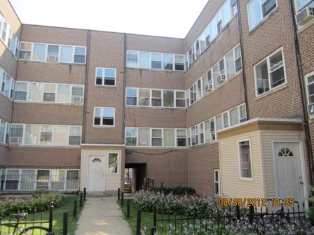 Front view of a multi-story brick apartment building.