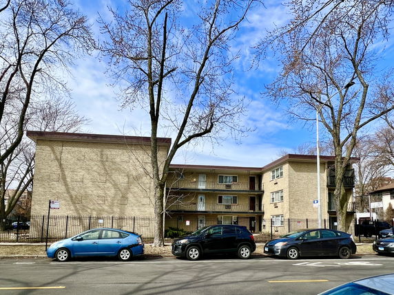 Front view of a three-story brick apartment building.