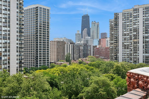 Panoramic view of a cityscape with tall buildings and trees.