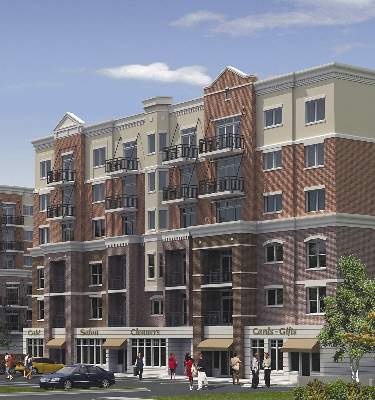 Front view of a multi-story commercial and residential building with shops on the ground floor.