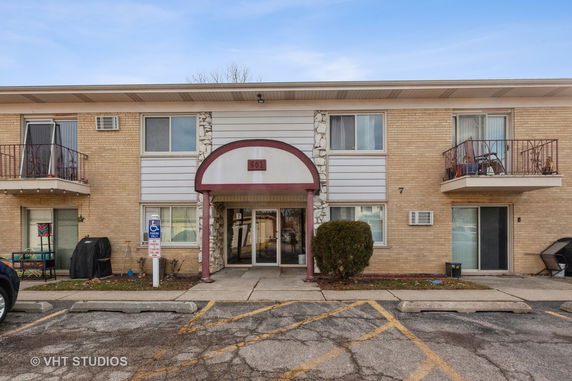 Front view of a two-story apartment building with balconies.