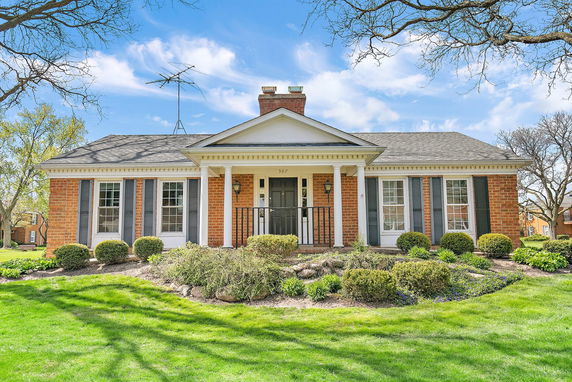 Front view of a single-story brick house with columns.