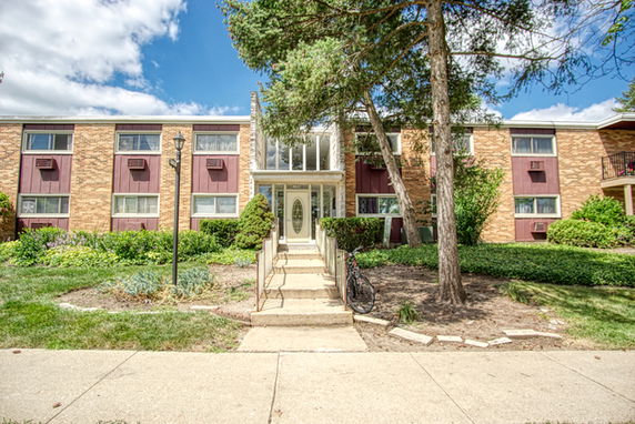 Front view of a two-story apartment building with a central entrance.