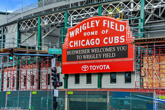 Front view of a stadium entrance with a prominent red sign.