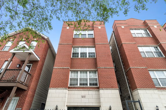Front view of a multi-story brick apartment building.