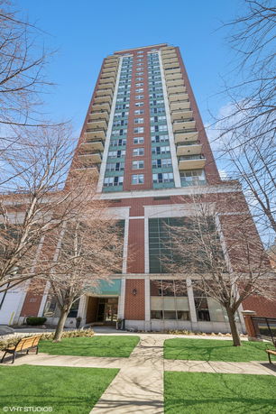Front view of a tall multi-story building with balconies.
