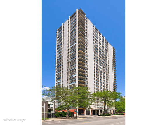 Front view of a high-rise building with multiple balconies.