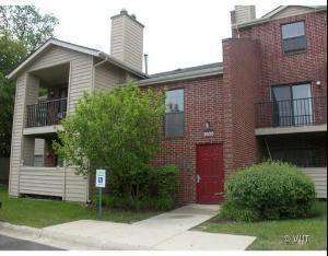 Front view of a two-story residential building with brick and siding exterior.