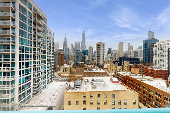 Panoramic cityscape view with multiple high-rise buildings and skyscrapers.