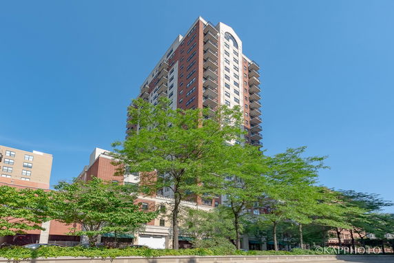 Front view of a multi-story residential building with balconies.