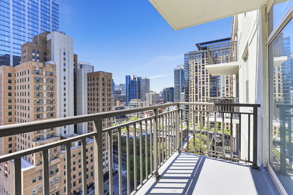 High-rise buildings seen from a balcony.