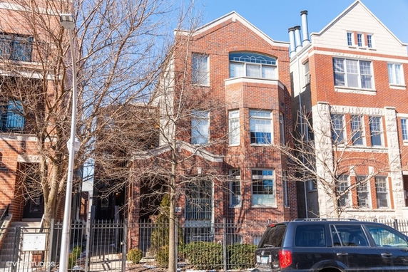 Front view of a brick multi-story residential building.