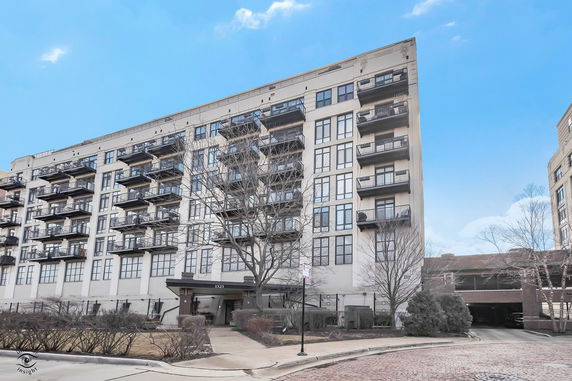 Front view of a multi-story building with balconies.