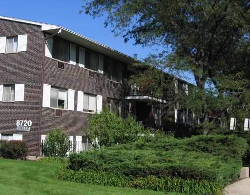 Front view of a two-story apartment building with a brick exterior.