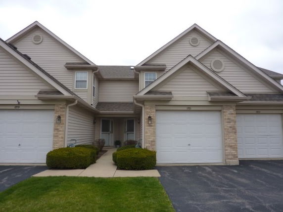Front view of a two-story house with attached double garages.