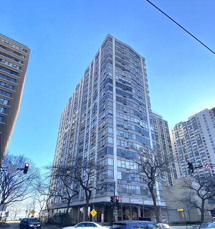Front view of a tall residential apartment building with multiple floors.