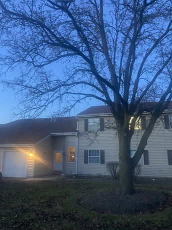 Front view of a two-story house with an attached garage.