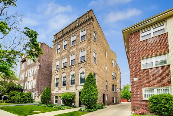 Front view of a three-story brick apartment building.