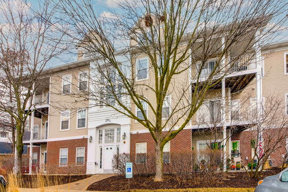 Front view of a multi-story residential building with balconies.