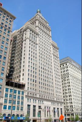 Front view of a tall, ornate multi-story building with classical architectural design.