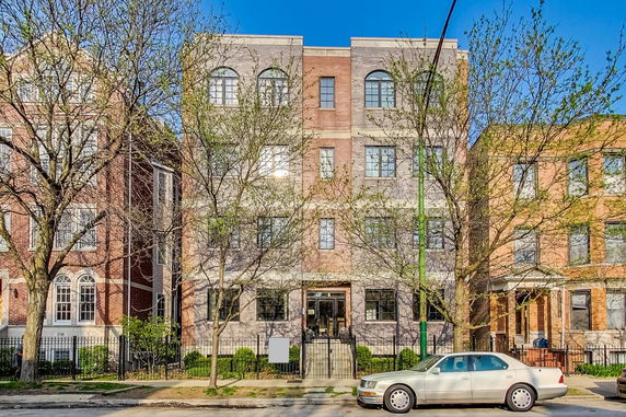 Front view of a multi-story building with a brick facade.