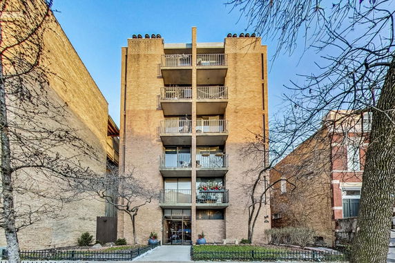 Front view of a mid-rise apartment building with balconies.
