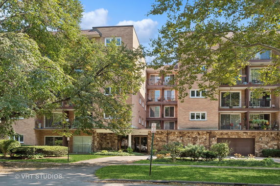 Front view of a multi-story apartment building with balconies.