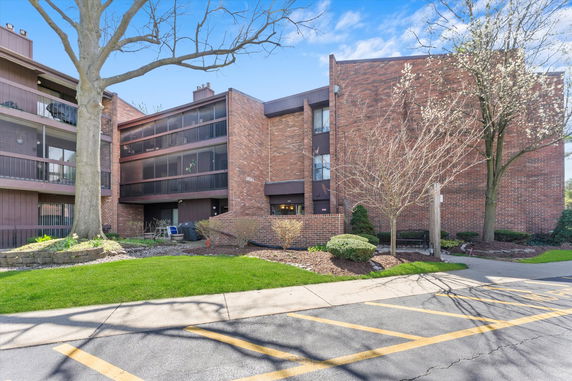 Front view of a multi-story brick building with balconies.