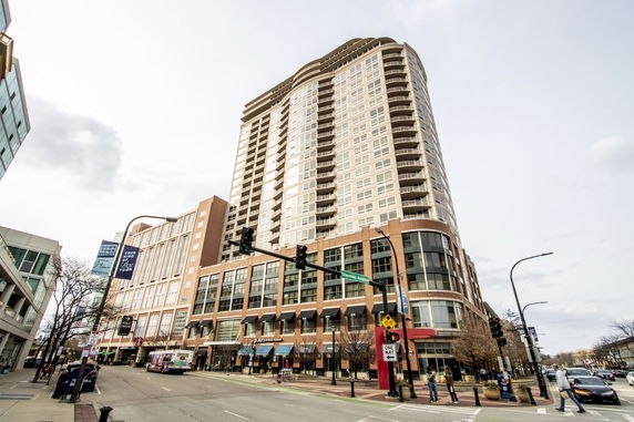 Front view of a high-rise building with multiple floors and large windows.