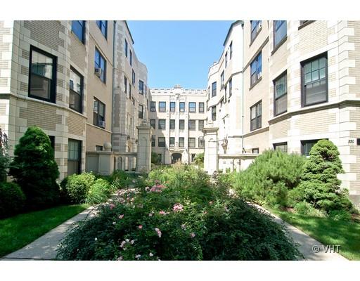 Front view of a multi-story residential building with courtyard.