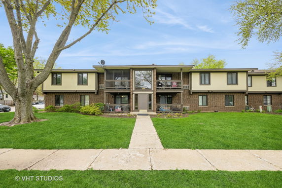 Front view of a two-story apartment building with balconies.